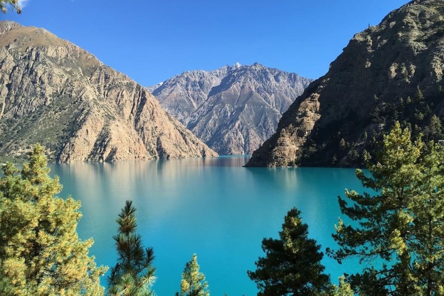 Phoksundo Lake's brilliant turquoise waters surrounded by steep mountain cliffs